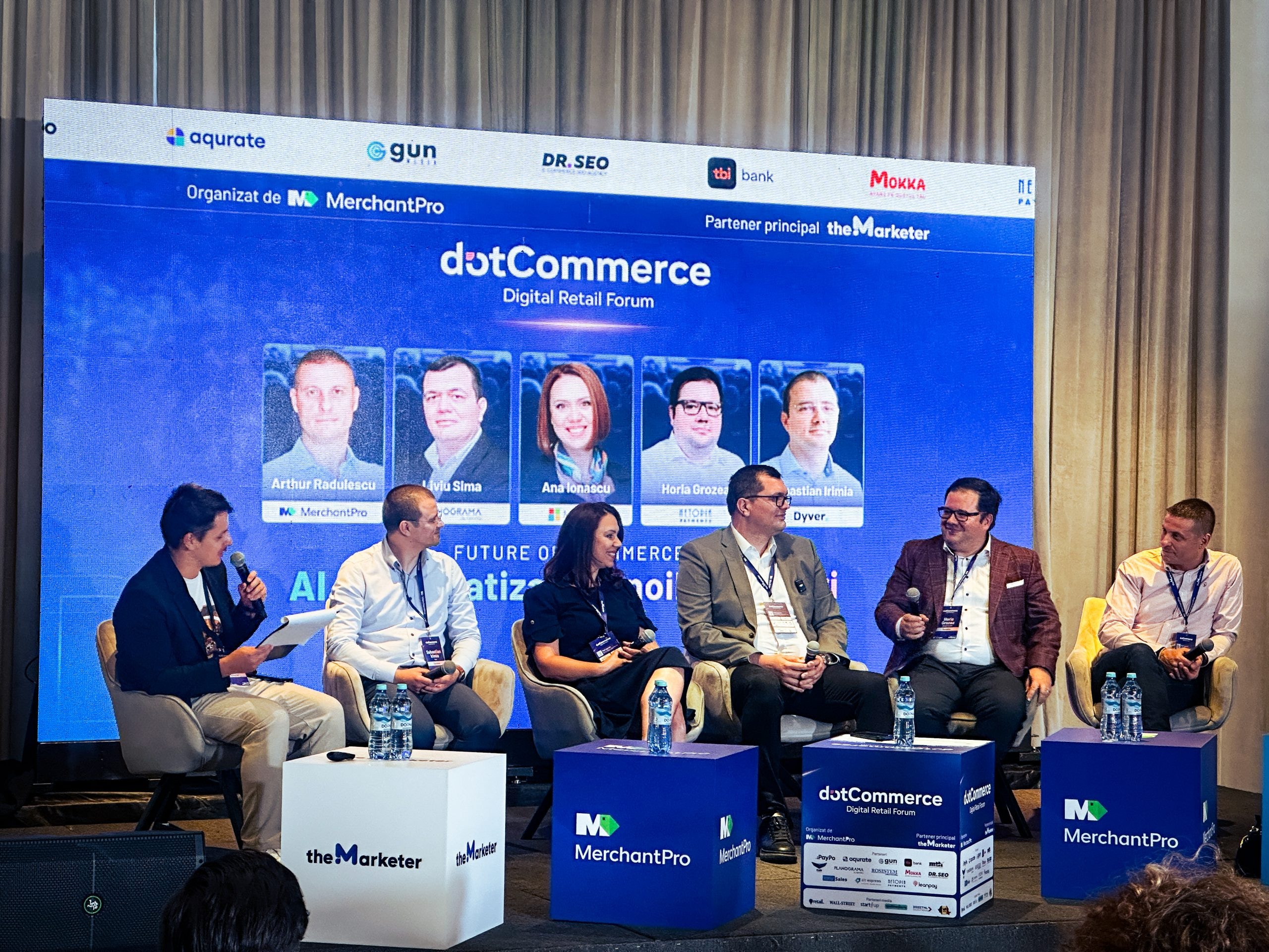 The AI and automation panel at dotCommerce Digital Retail Forum: a moderator and five panelists on stage, with the screen behind them listing the speakers, among them Liviu Sima of Planograma